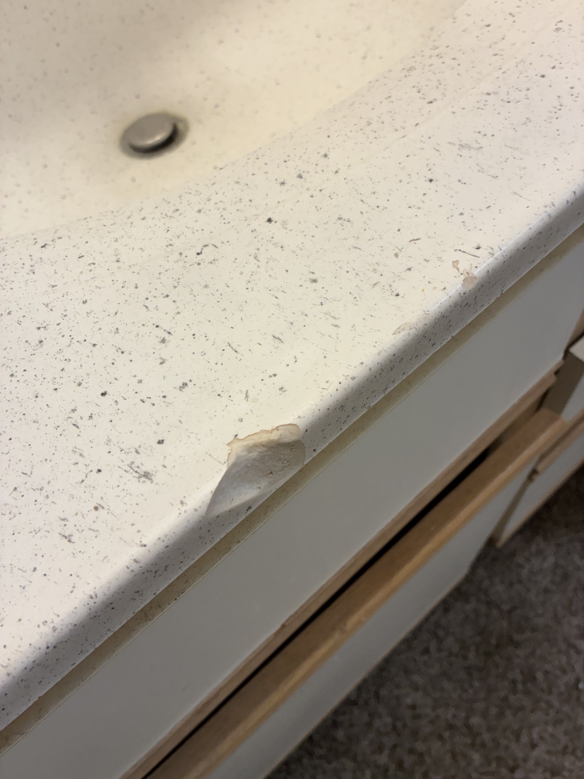 Worn bathroom countertop before refinishing